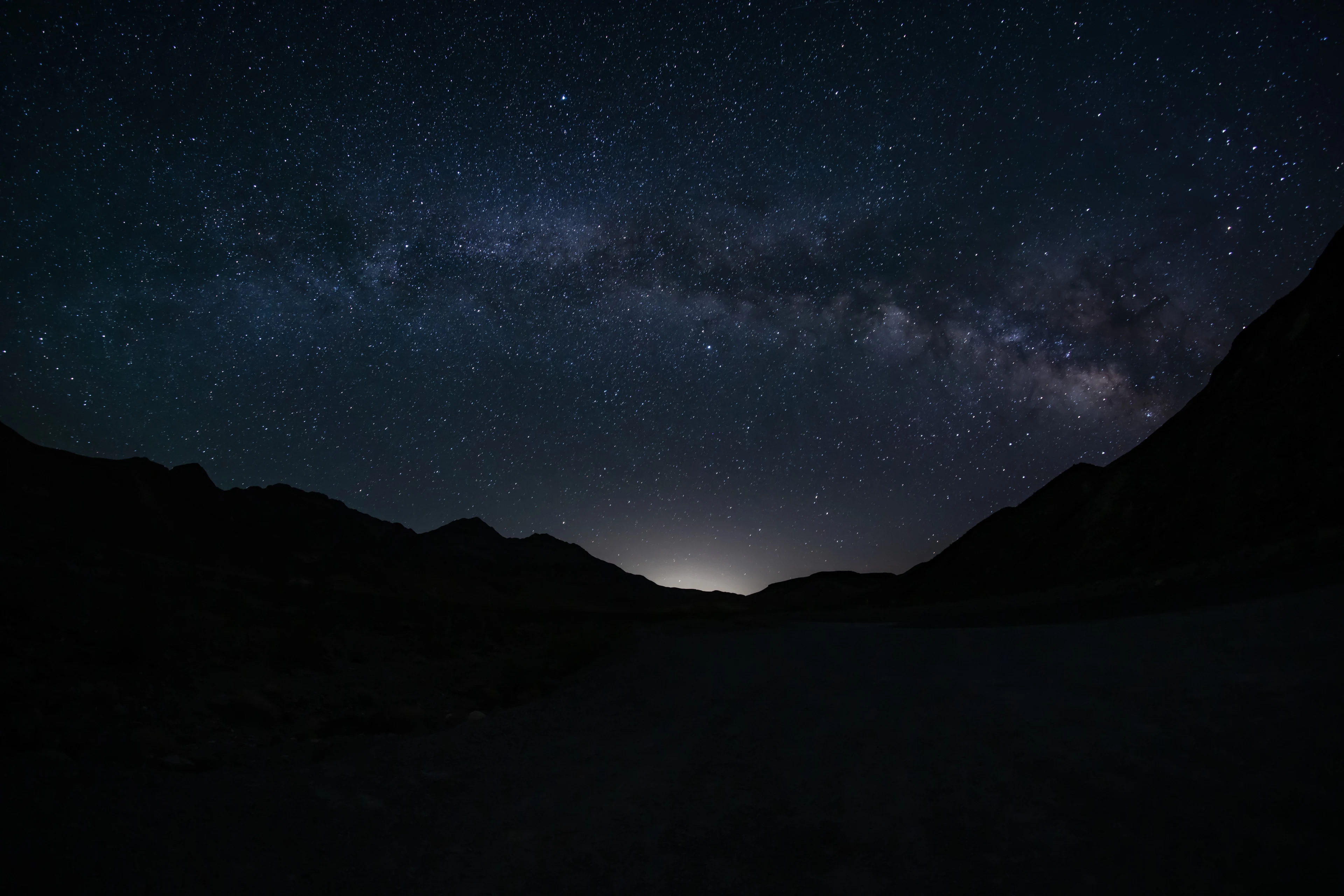 The Milky Way framed by dark mountains in Death Valley