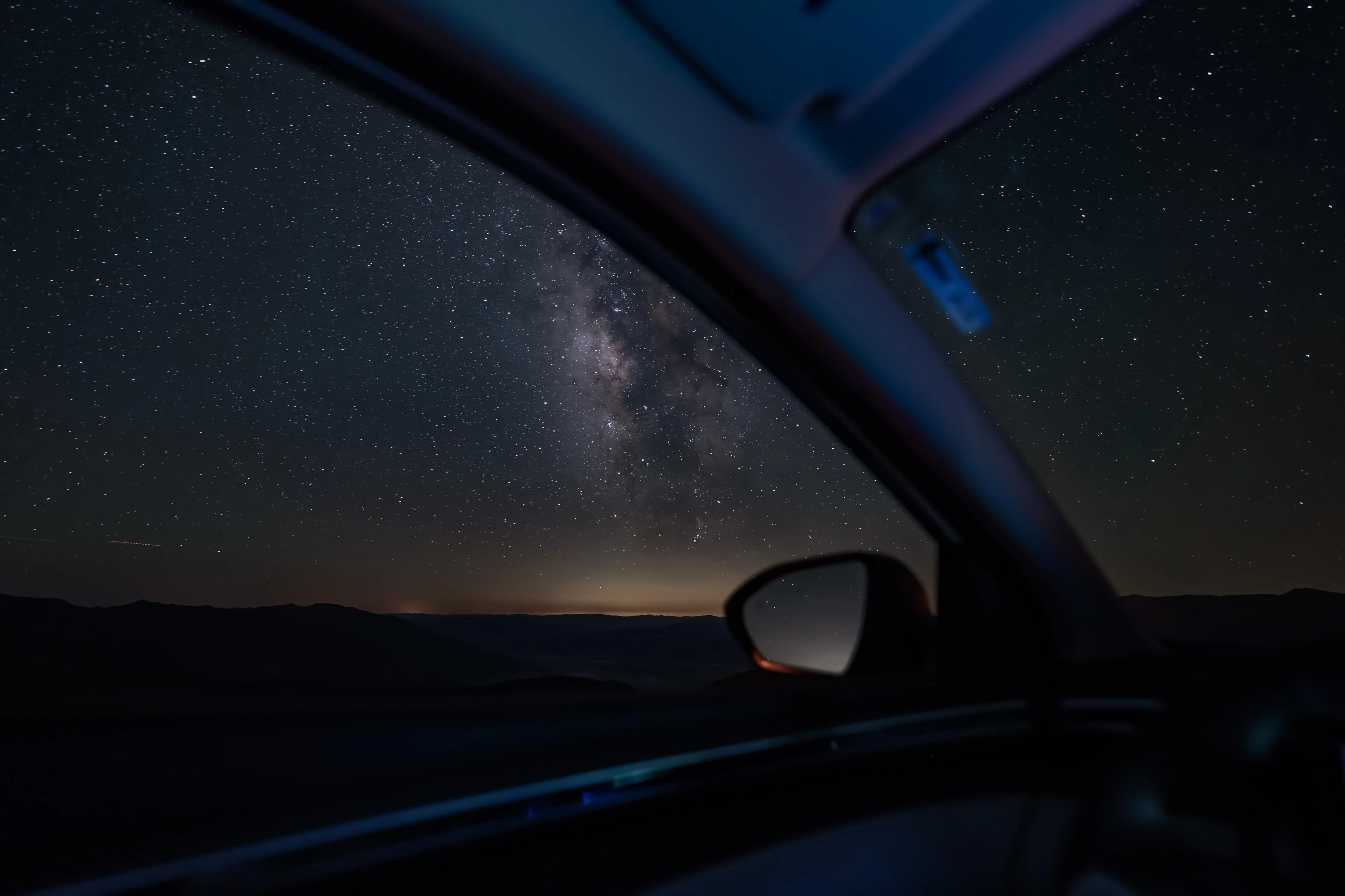 The Milky Way framed by an open car door in Death Valley