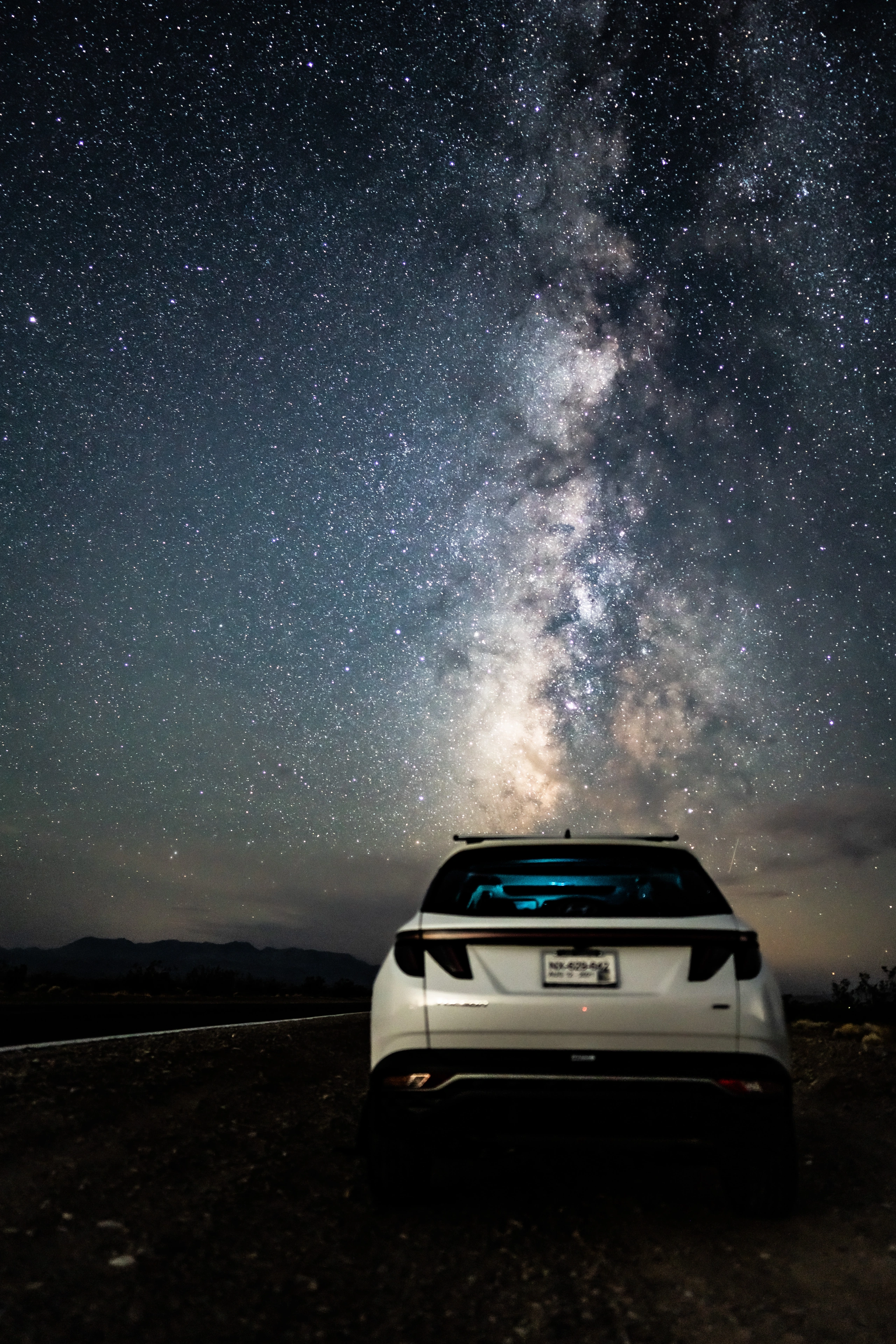 The Milky Way rising behind a car in the desert