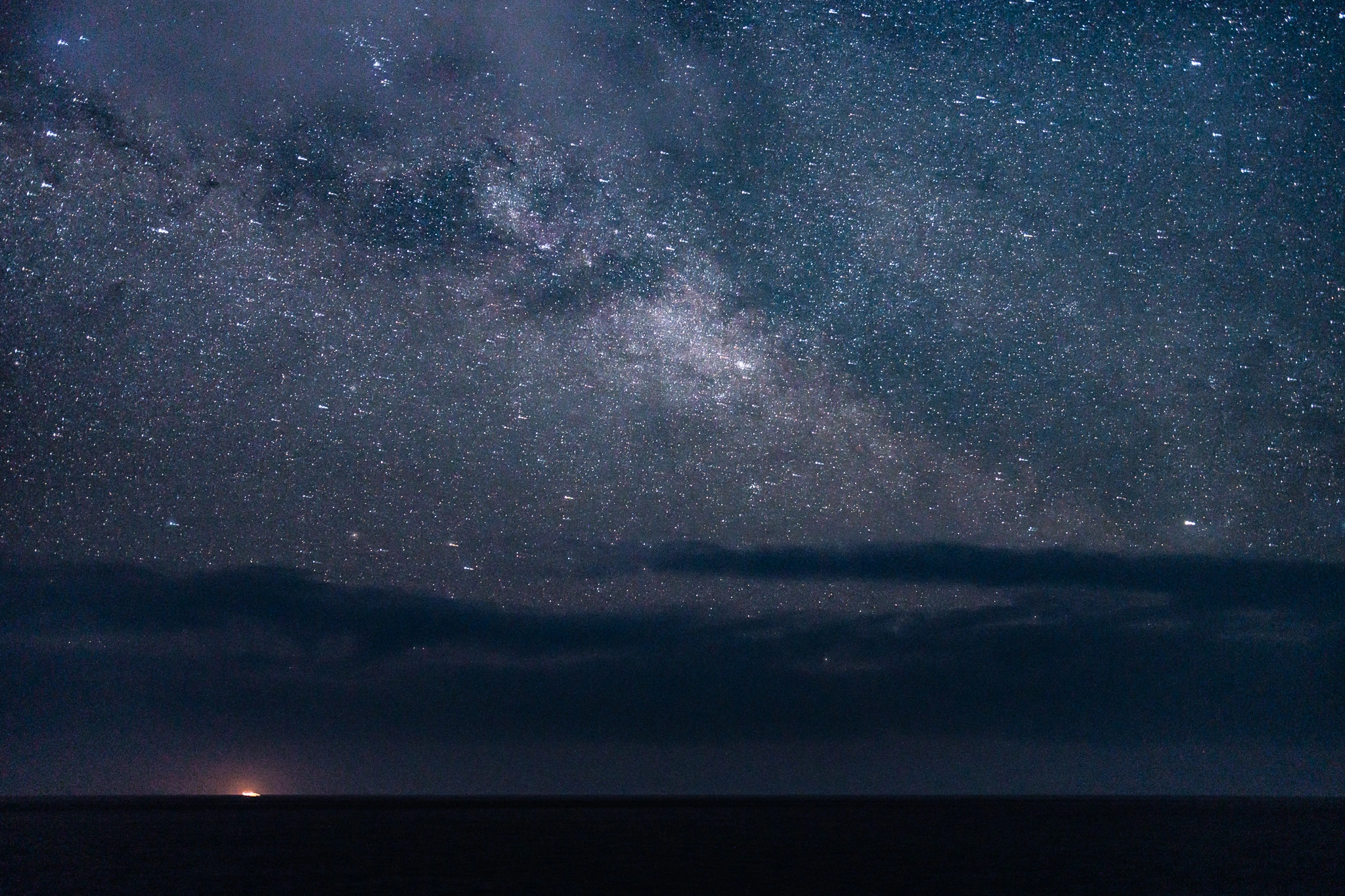 Stars and clouds above the dark Pacific