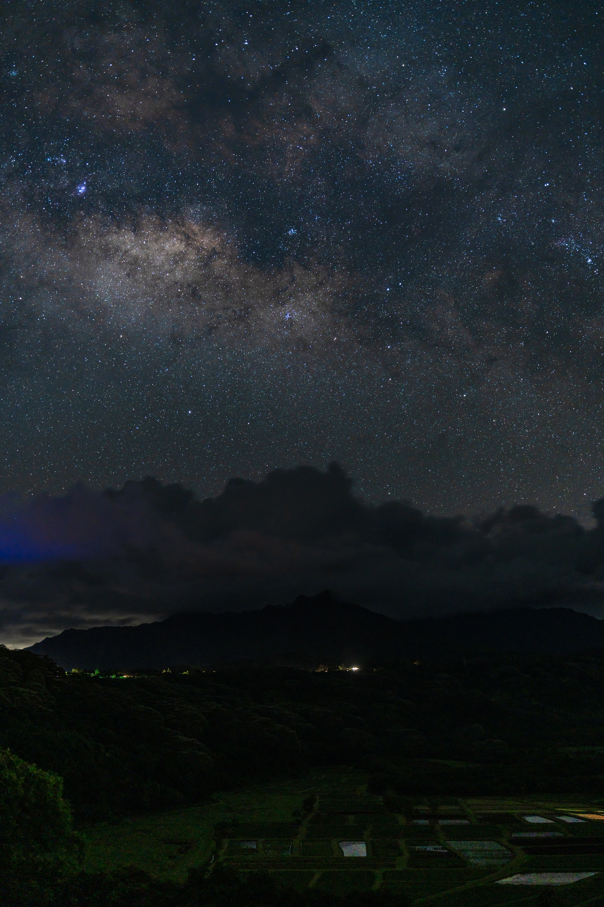 The Milky Way core above clouds and the dark Hanalei Valley