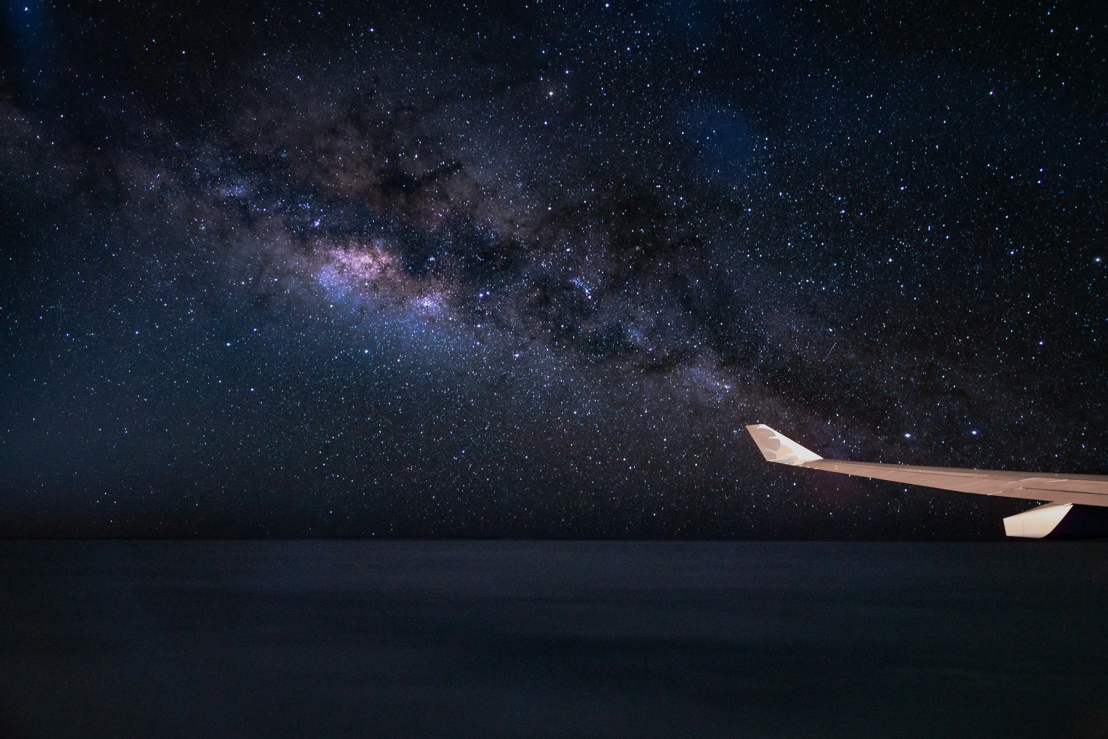 The Milky Way above the wing of an airplane over the Pacific