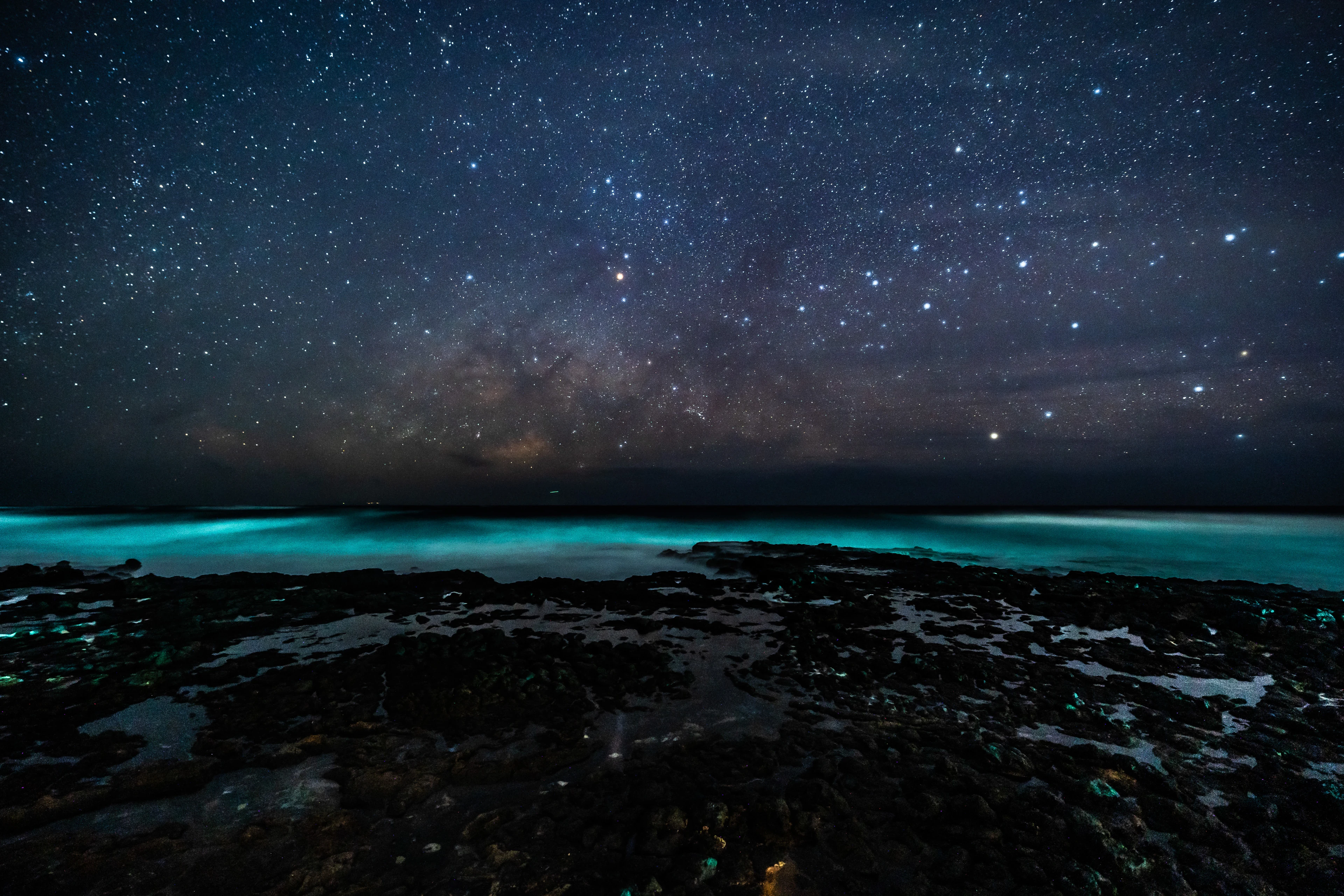 Turquoise surf beneath the Milky Way at Kaloko Beach