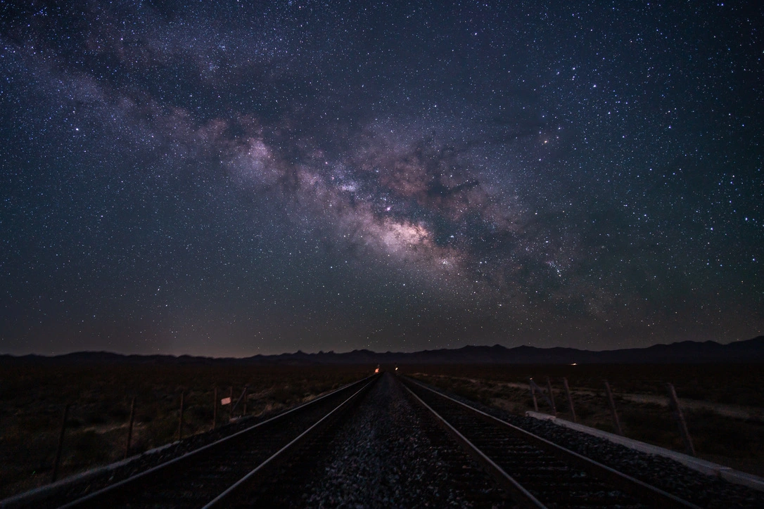 Railroad tracks running toward the Milky Way
