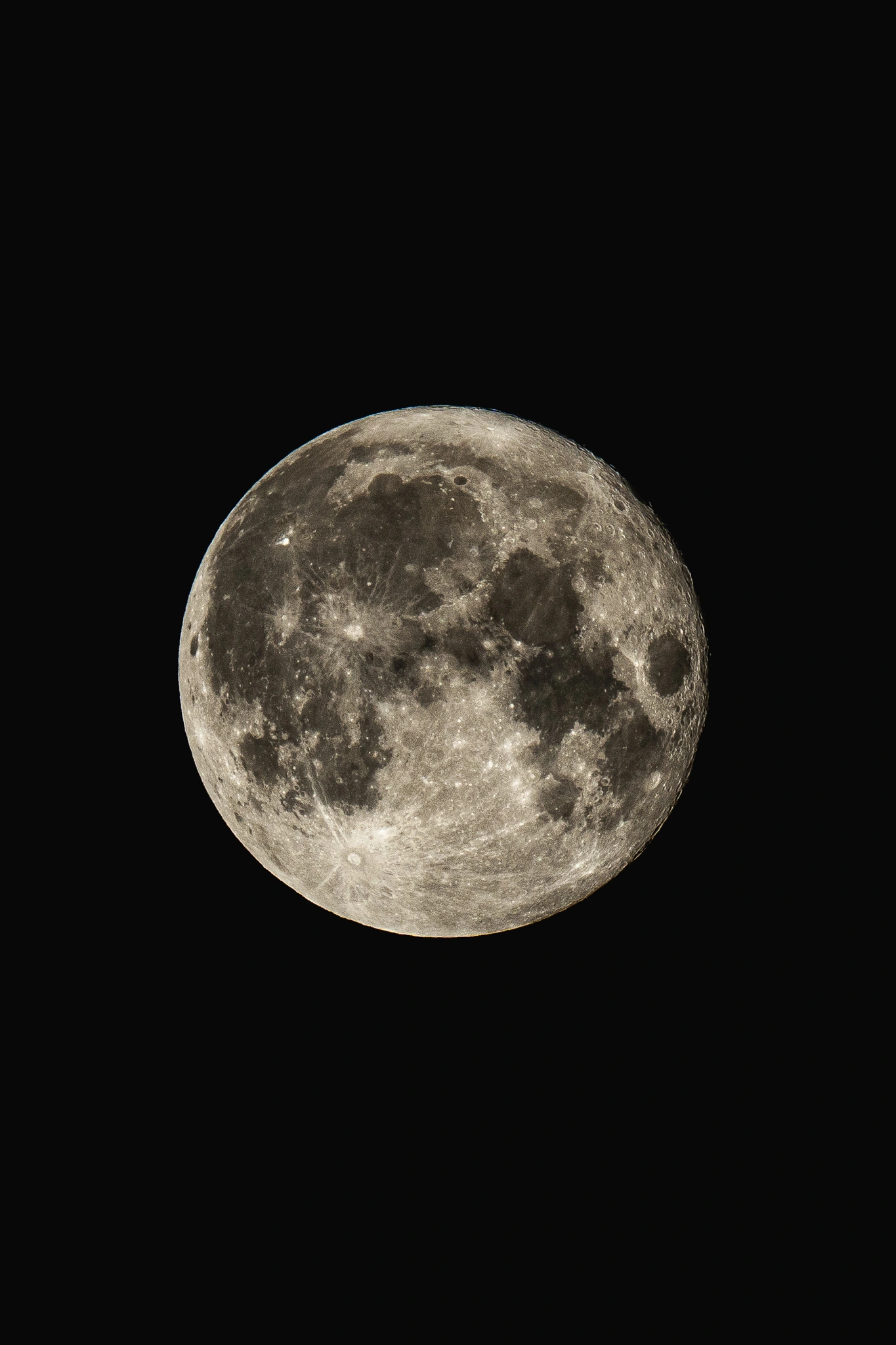 A detailed full moon against a black sky