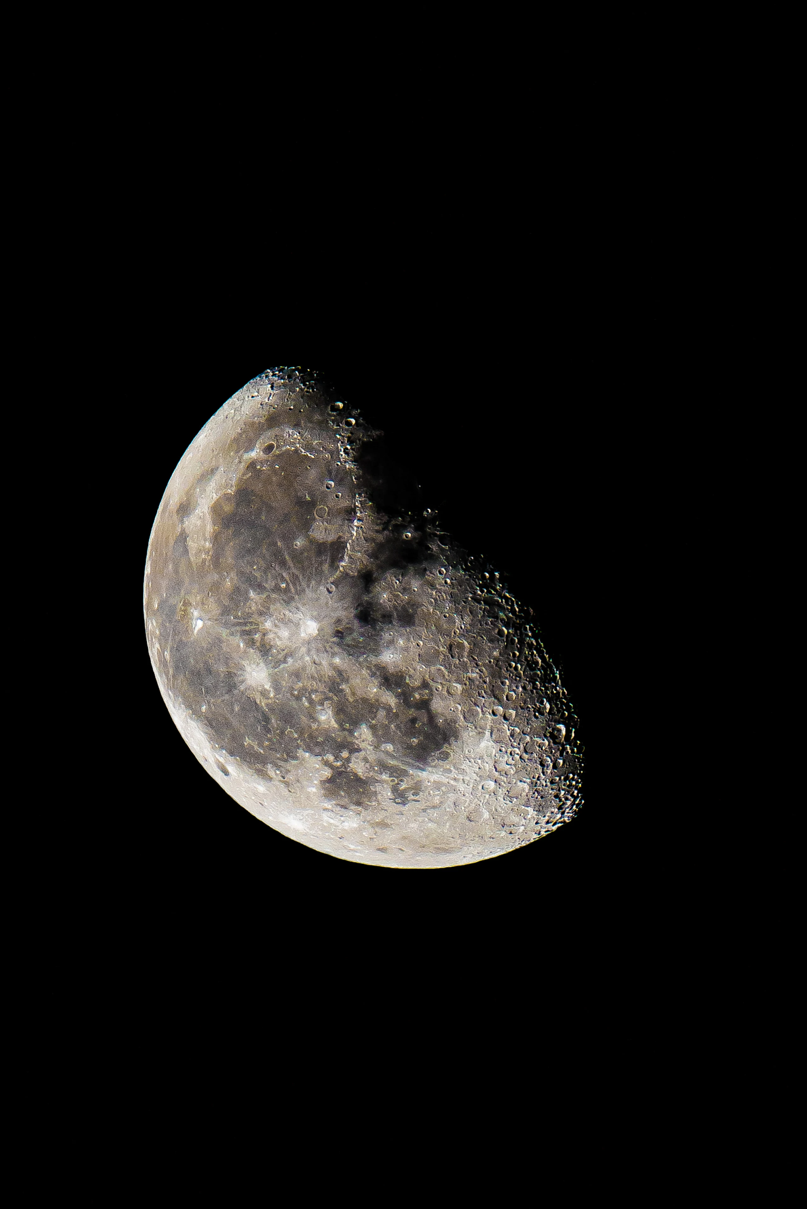 A detailed partial moon against a black sky