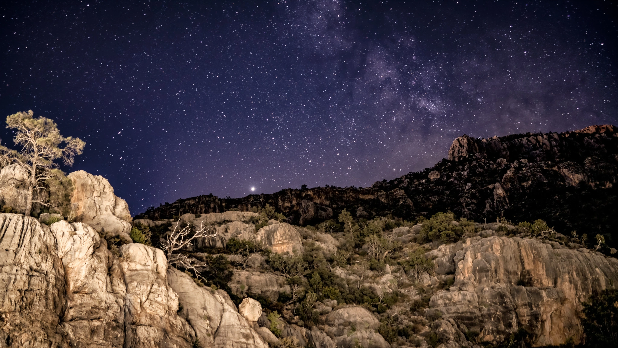 A field of stars above illuminated rocks at Mount Potosi