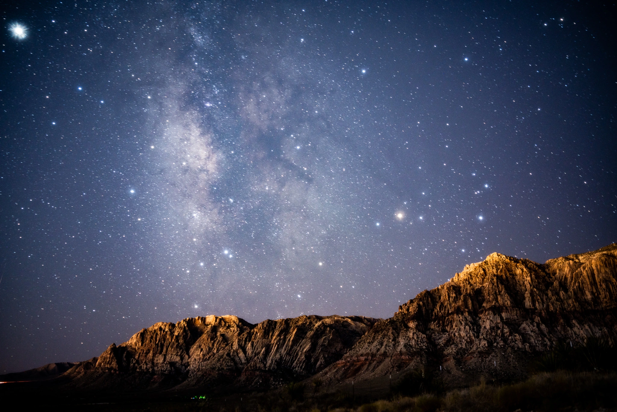The Milky Way above an illuminated ridge at Red Rock Canyon