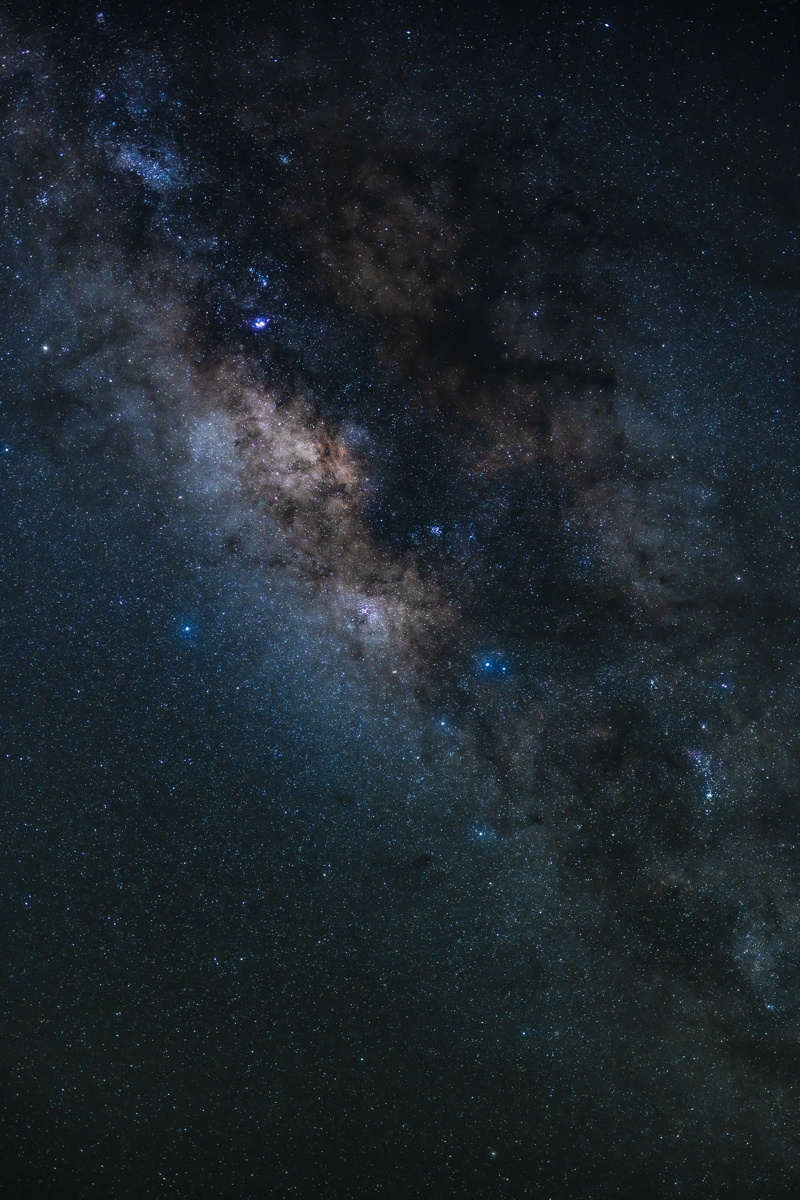 A close vertical view of the Milky Way core above Waimea Canyon